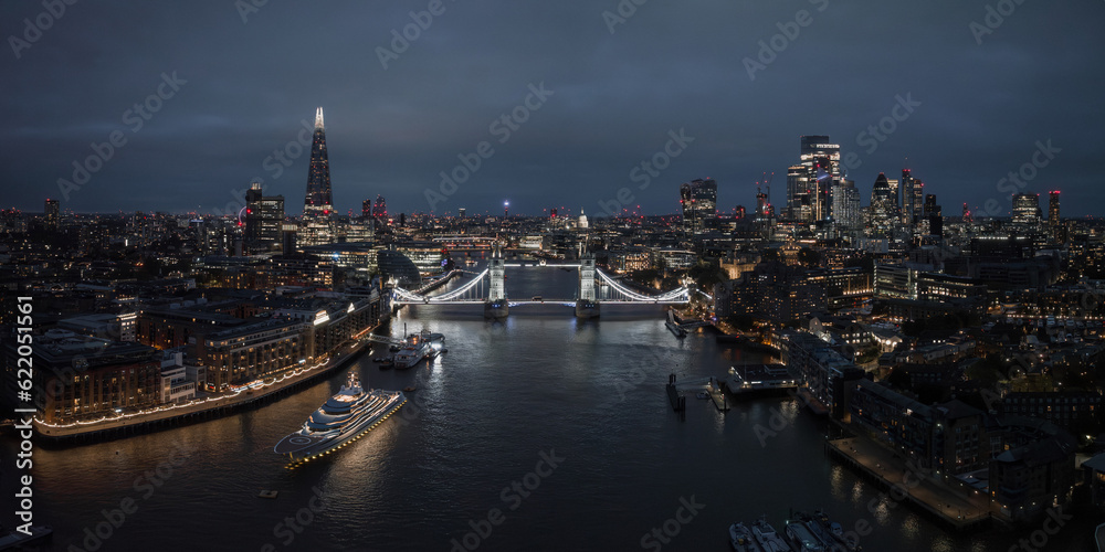 Fototapeta premium Aerial night view of the Tower Bridge in London. Beautiful illuminated panorama of London Tower Bridge at night.