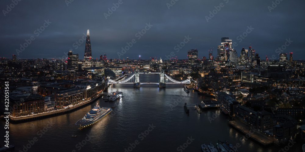 Aerial night view of the Tower Bridge in London. Beautiful illuminated panorama of London Tower Bridge at night.