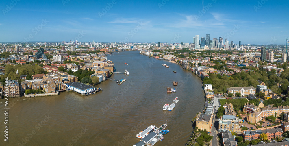 Beautiful panoramic view of London Thames river with Canary Wharf skyline in the background. Beautiful London district.