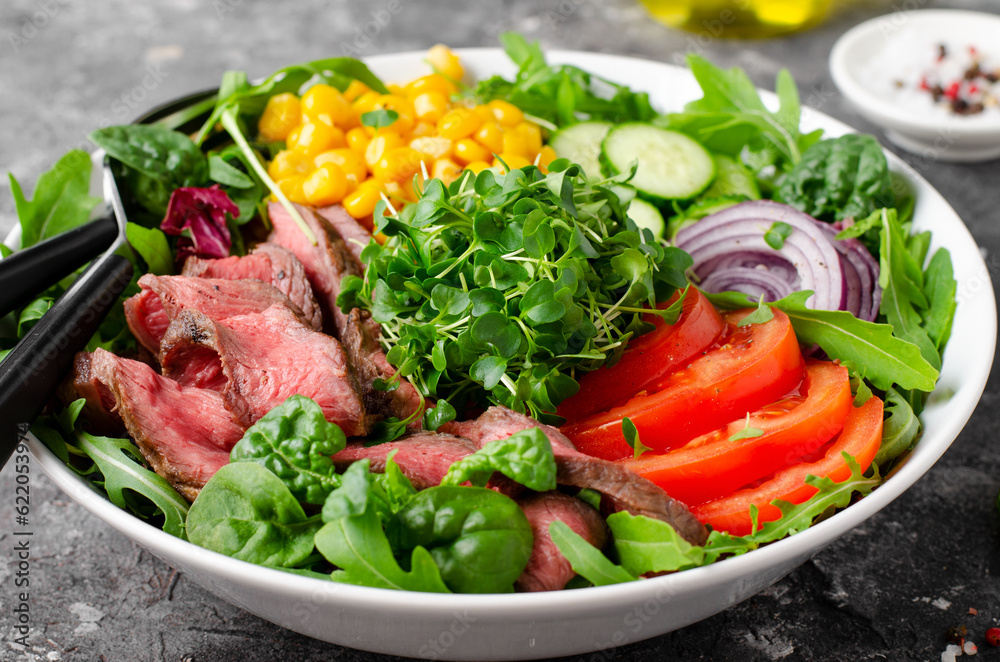 Beef steak and Fresh Vegetables Buddha Bowl, Healthy Balanced Meal on Dark Background Beef steak and Fresh Vegetables Buddha Bowl, Healthy Balanced Meal on Dark Background
