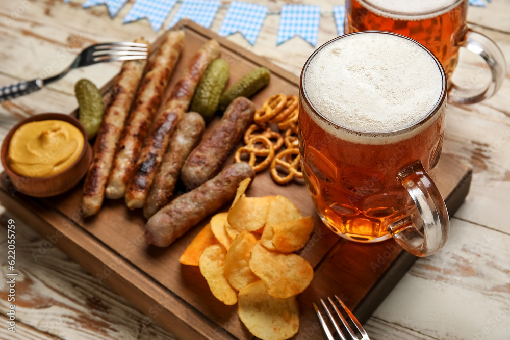 Mug of cold beer and different snacks on light wooden background. Oktoberfest celebration Mug of cold beer and different snacks on light wooden background. Oktoberfest celebration
