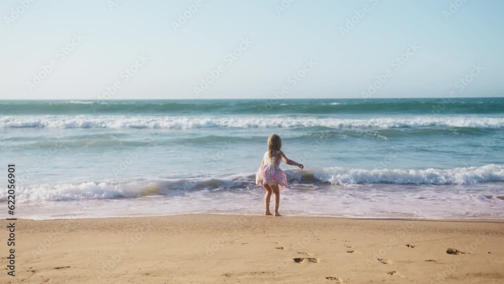 Summer vacation concept in slow motion with copy background. Happy family, love, dreaming kid concept 4K. Child girl having fun at sandy beach. Girl kid playing on ocean shore on warm sunny summer day Summer vacation concept in slow motion with copy background. Happy family, love, dreaming kid concept 4K. Child girl having fun at sandy beach. Girl kid playing on ocean shore on warm sunny summer day
