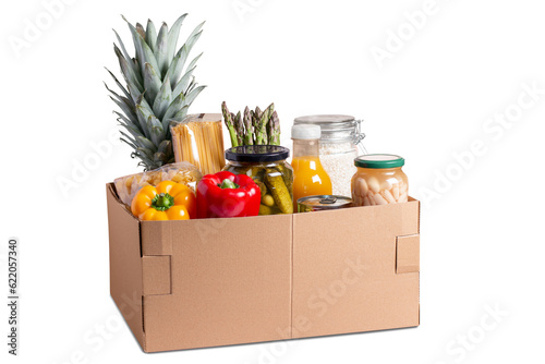 Isolated box with food for donation, charity concept. Canned food, pasta, fruits and vegetables in a box for donation isolated.