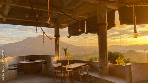 Empty cafe on sunrise with view on Batur volcano photo
