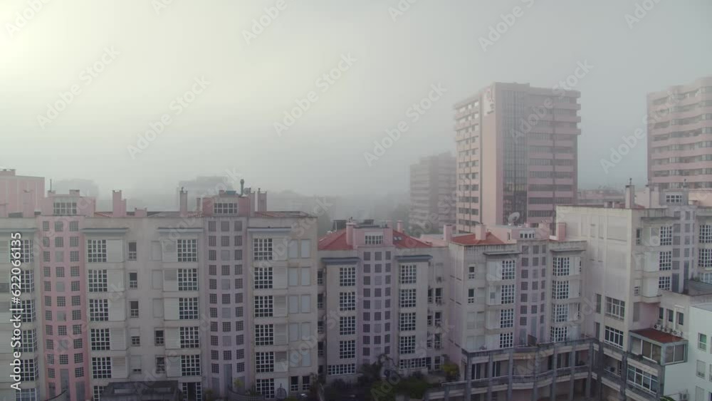Panning the city in the morning with heavy fog. Lisbon in the morning in foggy weather. European city in the early morning Panning the city in the morning with heavy fog. Lisbon in the morning in foggy weather. European city in the early morning