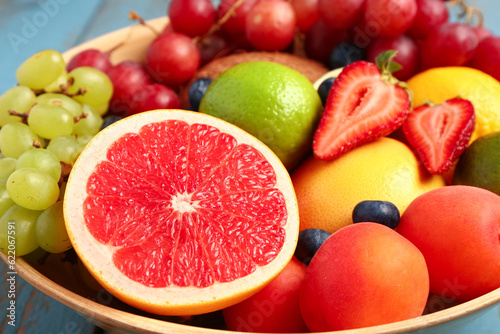 Bowl with different fresh fruits  closeup