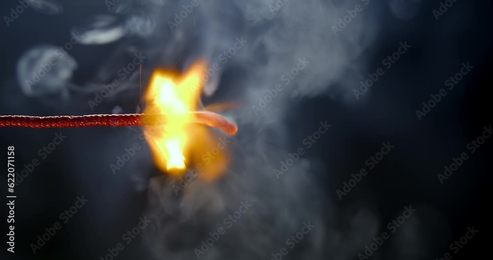 Following the lit fuse burning, sparking, and smoking.