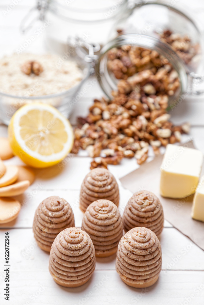 Traditional bee nest cake and ingredients on wooden background
