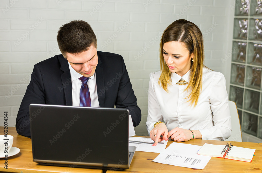 business couple working together on project at modern startup office. business couple working together on project at modern startup office.