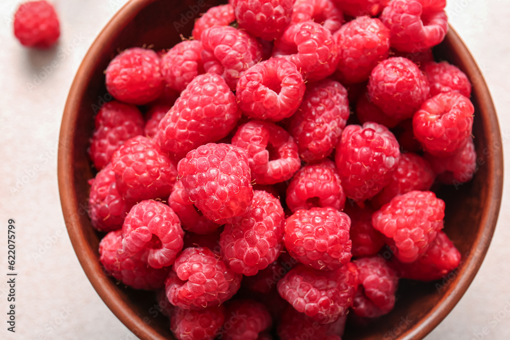 Bowl with fresh raspberries on white background Bowl with fresh raspberries on white background