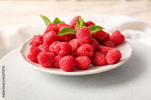 Plate with fresh raspberries and mint, closeup