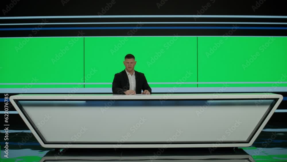 GREEN SCREEN CHROMA KEY Caucasian male anchorman reporting on a story in live news studio. Television newsroom channel with professional anchor presenter