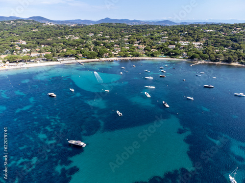 Crystal clear blue water of legendary Pampelonne beach near Saint-Tropez, summer vacation on white sandy beach of French Riviera, France