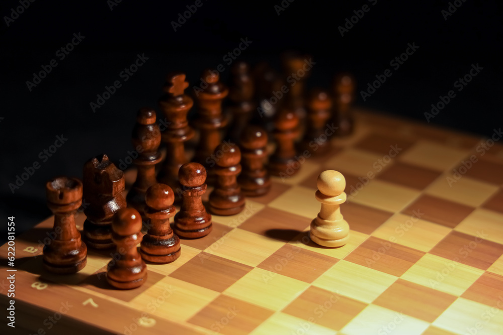 Game board with chess pieces on dark background, closeup