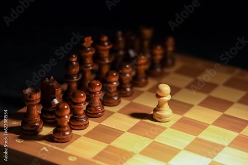 Game board with chess pieces on dark background, closeup