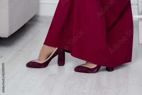 Burgundy shoes on a woman's feet.