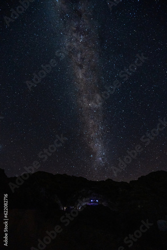 The Milky Way Galaxy moving over the mountain ridge. Night lapse from night to day. Starry night.