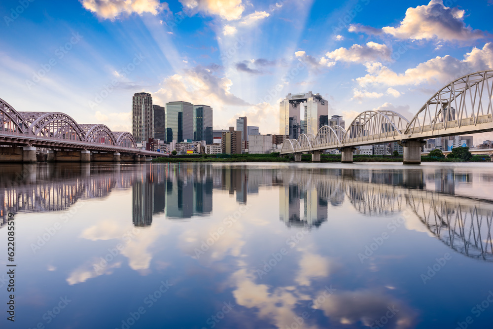 Osaka, Japan downtown skyline on the Yodogawa River at dawn. Osaka, Japan downtown skyline on the Yodogawa River at dawn.