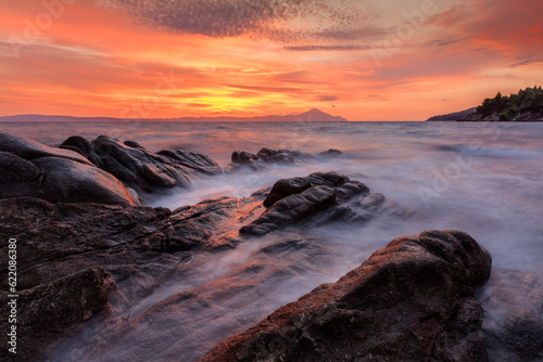 Vourvourou - Karidi beach with mount Athos in the background surprised at sunrise.