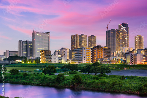 Kawasaki, Japan skyline on the Tamagawa River.