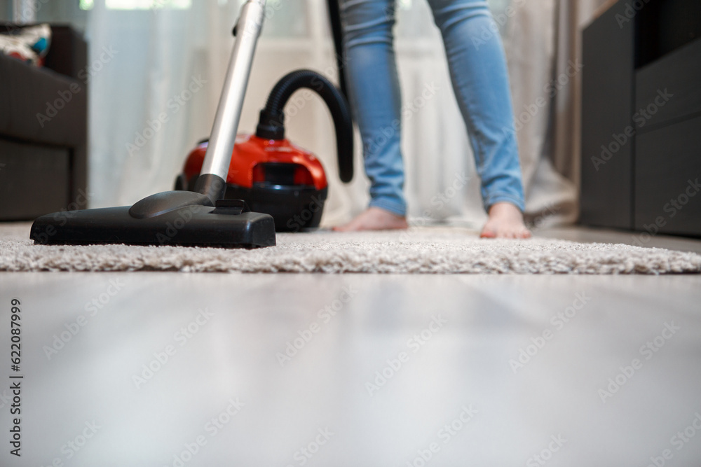 Woman with vacuum cleaner after cleaning. Home hygiene Woman with vacuum cleaner after cleaning. Home hygiene