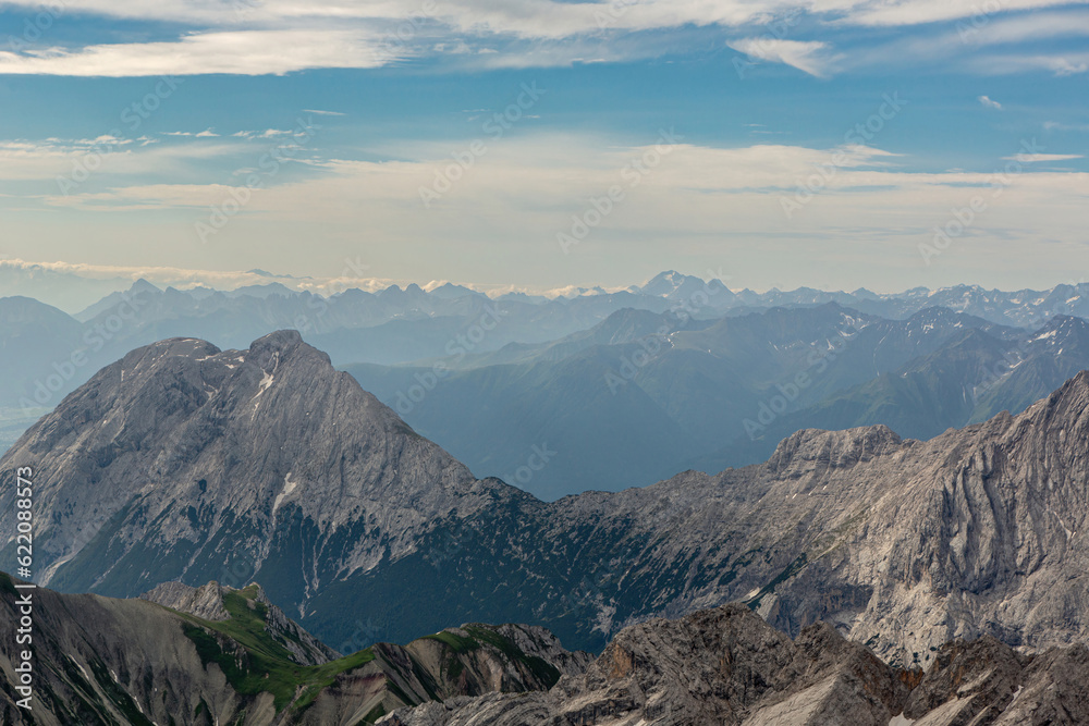 View from mount Zugspitze summit near Garmisch-Partenkirchen, Bavaria, Germany and Tyrol, Austria in summer outdoors. Alpine mountain panorama View from mount Zugspitze summit near Garmisch-Partenkirchen, Bavaria, Germany and Tyrol, Austria in summer outdoors. Alpine mountain panorama