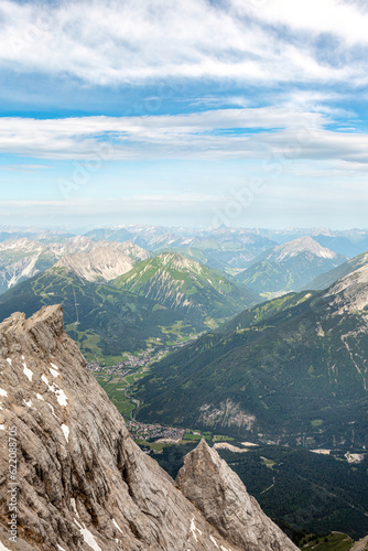 View from mount Zugspitze summit near Garmisch-Partenkirchen, Bavaria, Germany and Tyrol, Austria in summer outdoors. Alpine mountain panorama