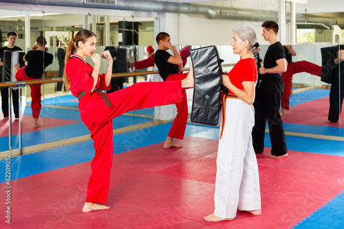 Fototapeta Naklejka Na Ścianę i Meble -  Two woman is training on the self defense course in gym