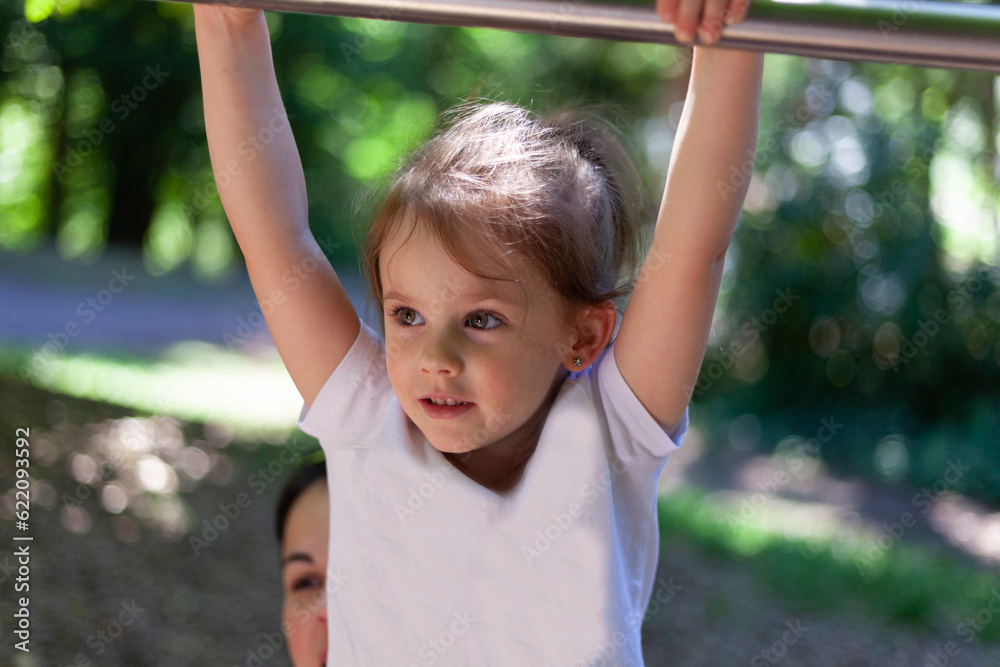 Portrait of a little girl on the playground. Selective focus.