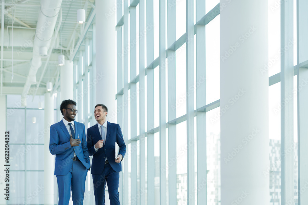 Smiling businessman in suit in office