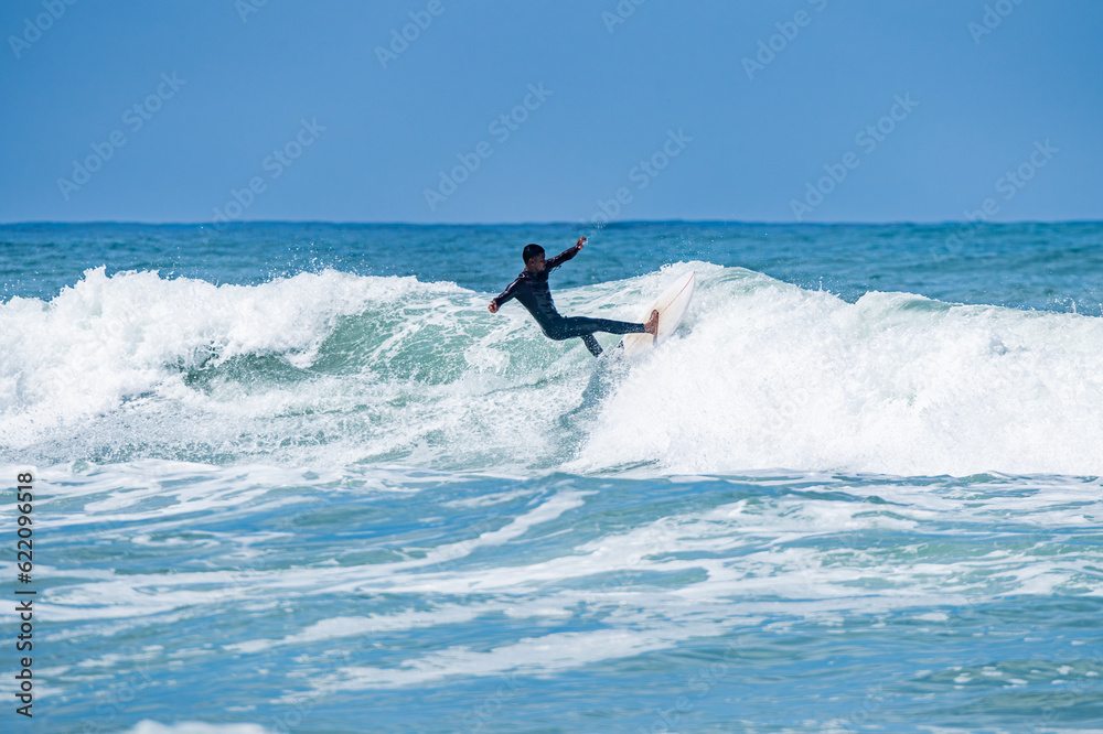 Surfer riding waves in Furadouro Beach Surfer riding waves in Furadouro Beach