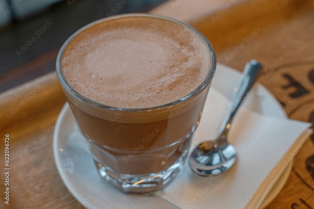 Hot espresso with white cup on black wood table, top view Hot espresso with white cup on black wood table, top view