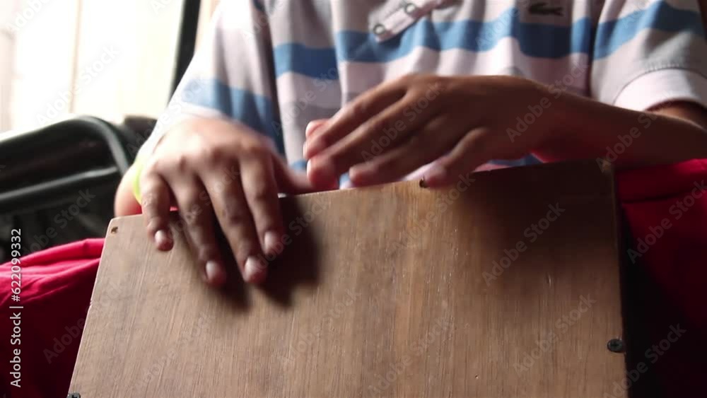 Percussionist playing a Traditional Boxshaped Percussion Instrument