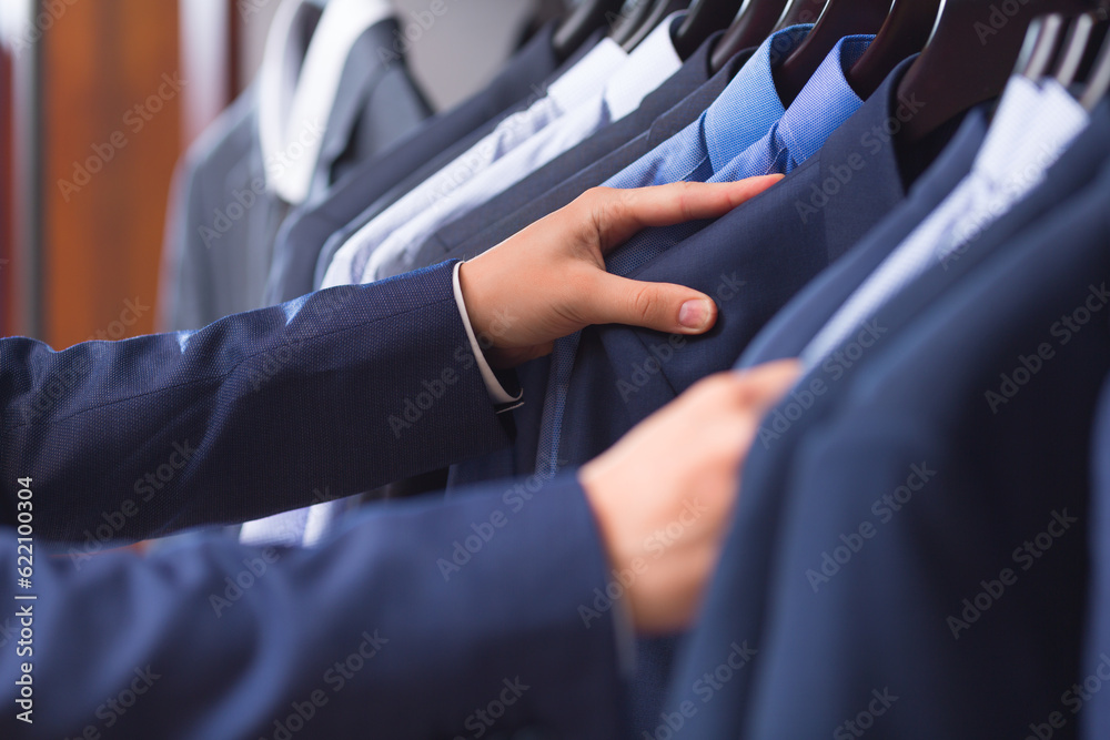 Male hand choosing a shirt Male hand choosing a shirt