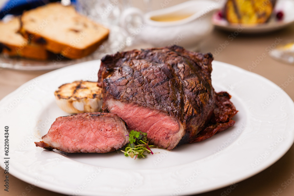 Entrecote with grilled garlic served on a plate Entrecote with grilled garlic served on a plate