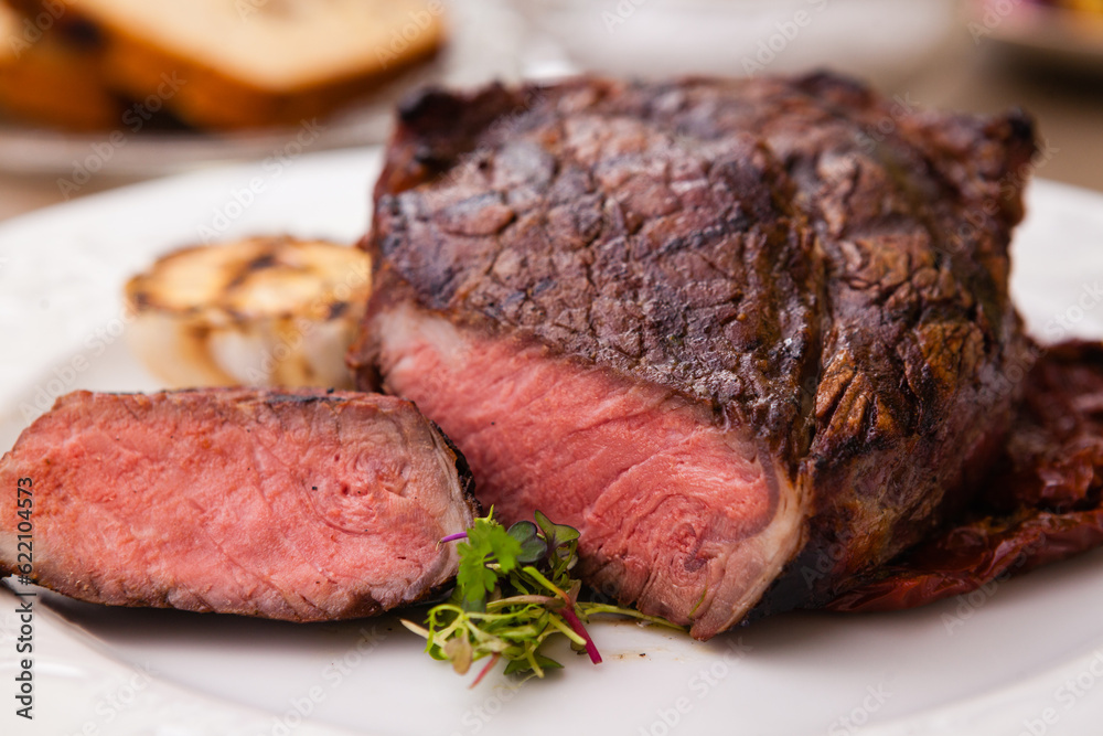 Entrecote with grilled garlic served on a plate Entrecote with grilled garlic served on a plate