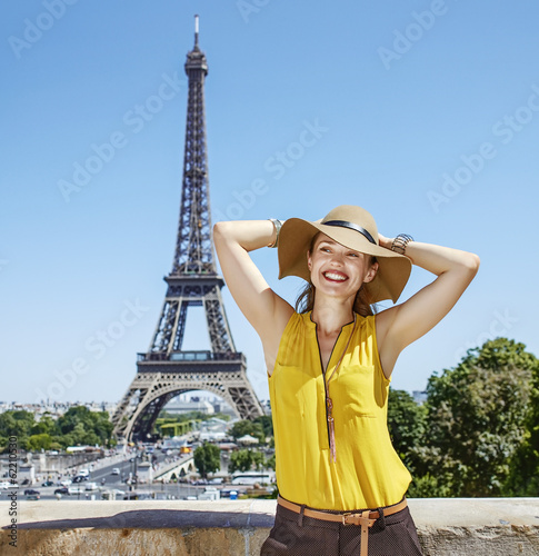 Having fun time near the world famous landmark in Paris. Portrait of relaxed young woman in bright blouse in the front of Eiffel tower © Designpics