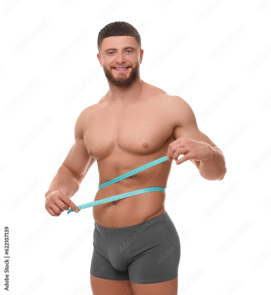 Portrait of happy athletic man measuring waist with tape on white background. Weight loss concept Portrait of happy athletic man measuring waist with tape on white background. Weight loss concept