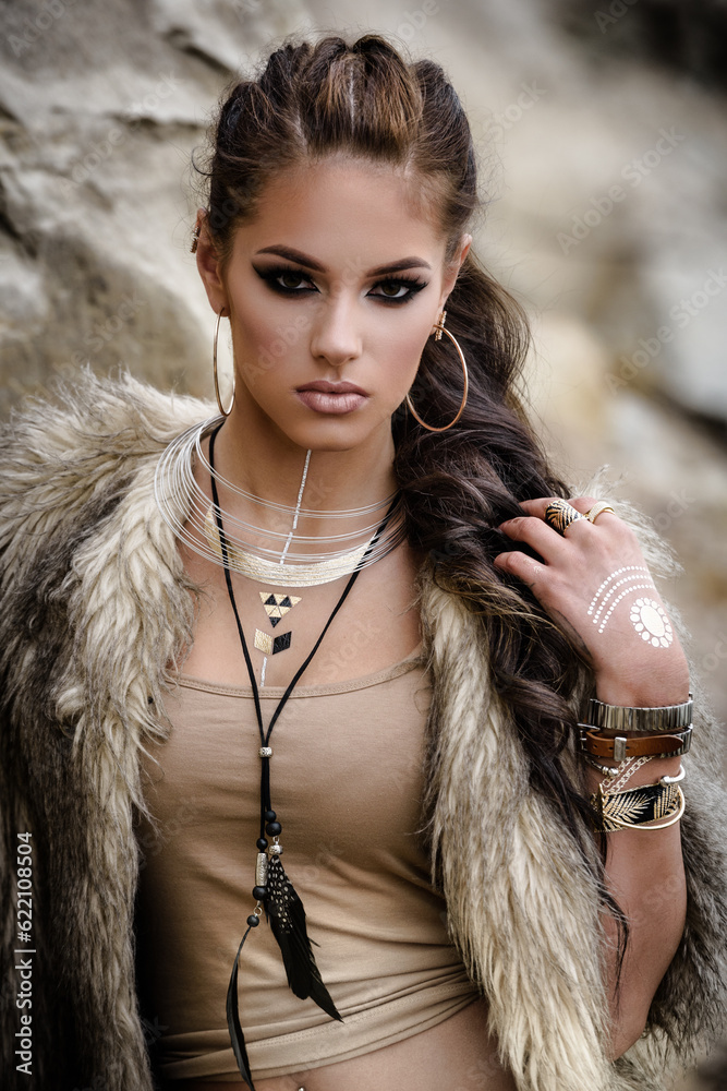 Portrait of a beautiful lady with flash tottoos posing outdoors near the sea
