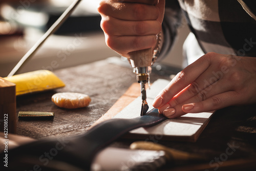 Leather handbag craftsman at work in a workshop