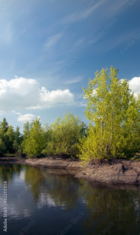 Outdoor nature. Daytime summer landscape with river and blue sky.