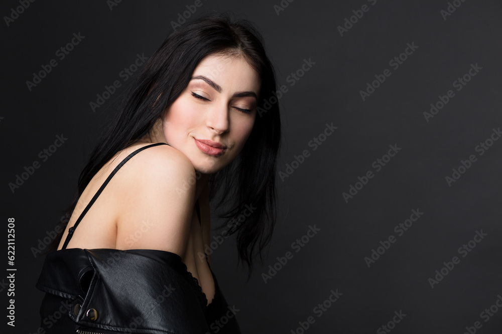 Portrait of happy beautiful brunnette model woman in lingerie or underwear posing with her eyes closed isolated on black background in studio. Portrait of happy beautiful brunnette model woman in lingerie or underwear posing with her eyes closed isolated on black background in studio.