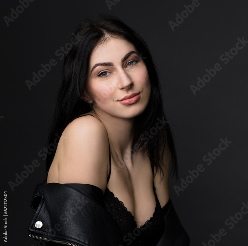 Portrait of beautiful brunnette model woman showing her delicake skin. Lady with beautiful smile posing for photographer in studio.