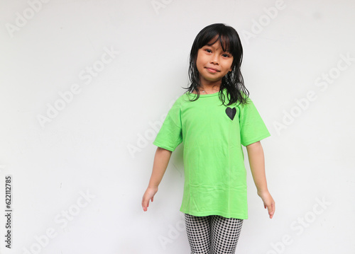 A cute smiling girl standing while looking at camera