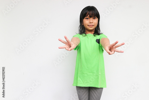 A cute girl raised her hand to show six of her fingers. Counting concept
