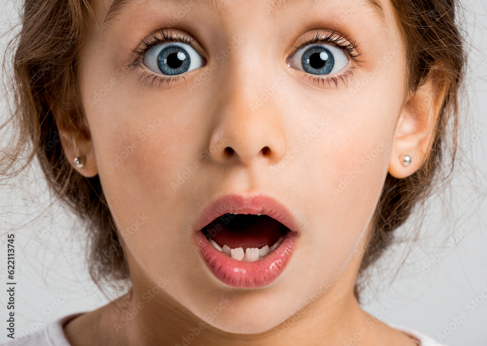 Studio portrait of a happy little girl with a astonished expression Studio portrait of a happy little girl with a astonished expression