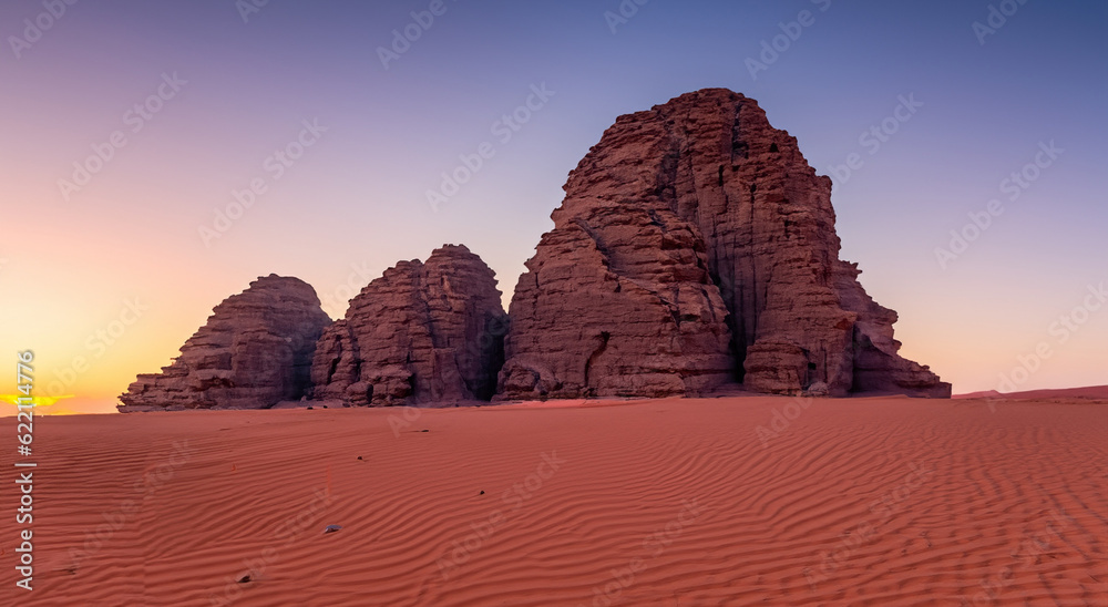 beautiful rock mountains in the middle of the desert in a beautiful sunset