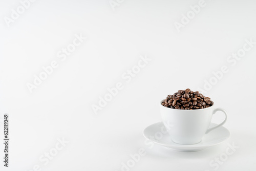 Coffee cup and beans  with copy space on white background.