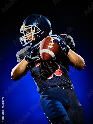 Bild auf Leinwand one american football player man isolated on colorful black background