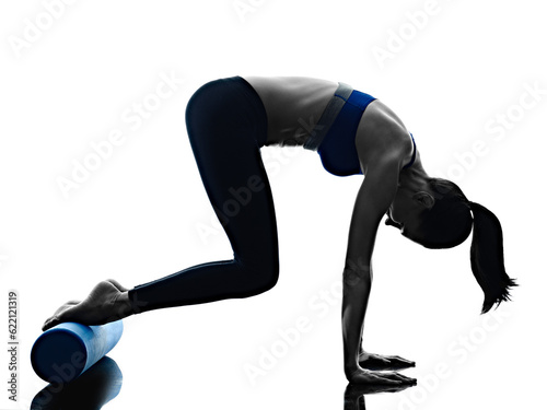 one caucasian woman exercising pilates roller exercises fitness in silhouette isolated on white backgound